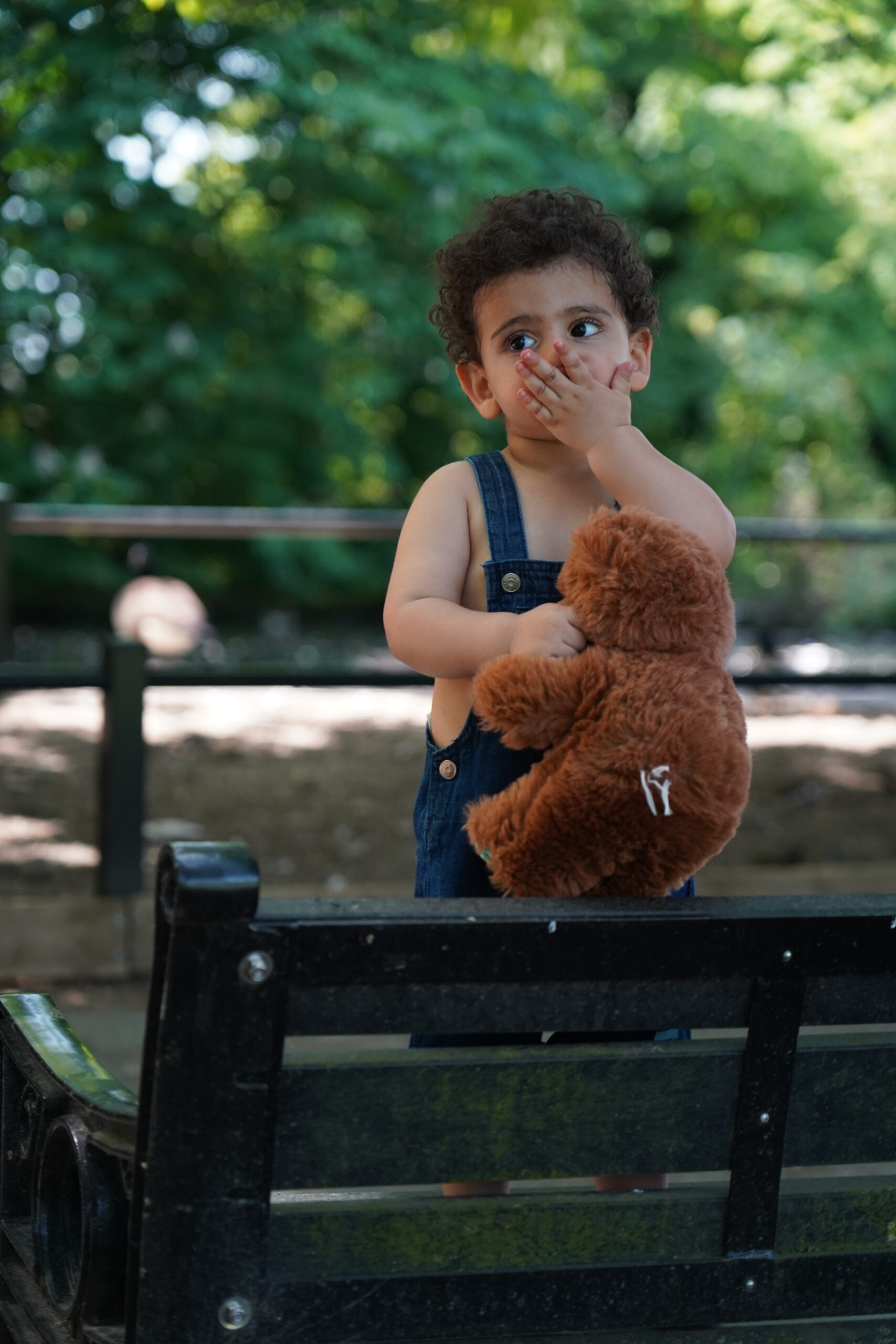 Best family photoshoot locations in Leeds: toddler holding a teddy bear in a park